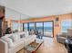 Spacious condo living room featuring ocean views, balcony access, and mirrored wall at 2121 Hill St # 7B, New Smyrna Beach, FL 32169