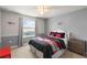 Cozy bedroom with grey walls, Mickey Mouse bedding, and natural light from the window at 2121 Morocco Way, Kissimmee, FL 34747