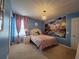 Charming bedroom with pastel blue walls, pink accents, a decorative chandelier, and a whimsical castle mural at 2121 Morocco Way, Kissimmee, FL 34747