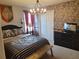 A themed bedroom with stone accent wall, TV, chandelier, and Hogwarts design elements at 2121 Morocco Way, Kissimmee, FL 34747