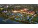 Aerial view of a resort style community pool with palm trees, water slides, and a lazy river at 2121 Morocco Way, Kissimmee, FL 34747