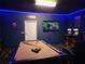 A spacious game room with a pool table, arcade games, a TV, and themed decorations at 2121 Morocco Way, Kissimmee, FL 34747