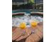 Relaxing hot tub with two glasses of juice by the pool, perfect for unwinding and enjoying the spa experience at 2121 Morocco Way, Kissimmee, FL 34747
