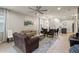 Open-concept living room with tile floors, comfortable seating, and lots of natural light at 2121 Morocco Way, Kissimmee, FL 34747