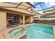 A private pool and spa with an outdoor dining and lounge area, perfect for relaxation at 2121 Morocco Way, Kissimmee, FL 34747