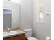 Bathroom featuring single sink vanity, toilet, and window at 2211 J Lawson Blvd, Orlando, FL 32824