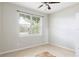 Bright bedroom featuring tile floors, a large window, and a ceiling fan at 2211 J Lawson Blvd, Orlando, FL 32824