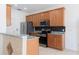 Kitchen with stainless steel appliances, granite counters and wood cabinets at 2211 J Lawson Blvd, Orlando, FL 32824