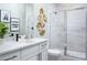 Modern bathroom with sleek vanity, decorative mirror, and glass-enclosed shower at 2374 Celebration Blvd, Celebration, FL 34747