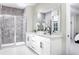Elegant bathroom featuring a double vanity, large mirror, and a glass-enclosed shower at 2374 Celebration Blvd, Celebration, FL 34747