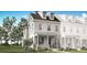 Charming two-story home with a welcoming front porch and manicured lawn at 2374 Celebration Blvd, Celebration, FL 34747