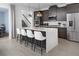 Modern kitchen with a large island, stainless steel appliances, and dark cabinets at 2374 Celebration Blvd, Celebration, FL 34747