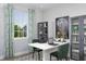 Bright office space with stylish decor, a modern white desk, and a large window with patterned curtains at 2374 Celebration Blvd, Celebration, FL 34747