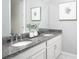 Bathroom featuring dual sinks with granite countertop and framed mirror at 2380 Celebration Blvd, Celebration, FL 34747