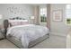 Serene bedroom featuring plush bedding, decorative wall art, and a bright window view at 2380 Celebration Blvd, Celebration, FL 34747