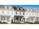 Charming new construction townhome featuring a welcoming front porch and classic architectural details at 2380 Celebration Blvd, Celebration, FL 34747