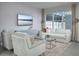 Bright living room with a large window, modern furniture, and a neutral color palette at 2380 Celebration Blvd, Celebration, FL 34747