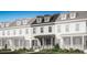 Charming two-story townhome with covered porch and manicured landscaping at 2386 Celebration Blvd, Celebration, FL 34747