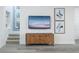 Modern entryway featuring staircase, wood cabinet and contemporary artwork at 2386 Celebration Blvd, Celebration, FL 34747