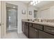 Stylish bathroom with dual sinks, granite countertops, and a walk-in shower at 2438 Dubai St, Kissimmee, FL 34747