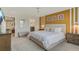 Bright bedroom with a mustard wall and decorative wall hangings over the tufted headboard at 2438 Dubai St, Kissimmee, FL 34747