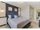 Bedroom featuring a bed with grey linens, a dark accent wall, and modern lighting fixtures at 2438 Dubai St, Kissimmee, FL 34747