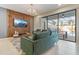 Cozy living room featuring a wood accent wall, contemporary lighting, and a view of the screened-in lanai at 2438 Dubai St, Kissimmee, FL 34747