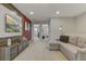 Spacious living room with a large sectional sofa and a wall-mounted television at 2438 Dubai St, Kissimmee, FL 34747