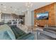Inviting living room adjacent to kitchen featuring modern decor, stylish furniture, and a decorative accent wall at 2438 Dubai St, Kissimmee, FL 34747