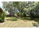 Serene backyard featuring picnic table, shade trees, and plenty of space for outdoor enjoyment at 26 Canter Club Ct, Debary, FL 32713