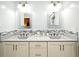 Bright bathroom featuring double sinks, ample counter space, and modern fixtures at 26 Canter Club Ct, Debary, FL 32713