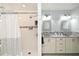 Bathroom with a white shower curtain, tiled shower and a double vanity sink at 26 Canter Club Ct, Debary, FL 32713