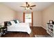 Cozy bedroom with hardwood floors, neutral walls, and a ceiling fan at 26 Canter Club Ct, Debary, FL 32713