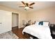 Bedroom features wood floors, a ceiling fan, and a closet for storage at 26 Canter Club Ct, Debary, FL 32713