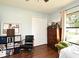 Bedroom features hardwood floors, a chair, and closet for storage at 26 Canter Club Ct, Debary, FL 32713