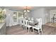 Elegant dining room features a stylish chandelier and a large window with natural light at 26 Canter Club Ct, Debary, FL 32713