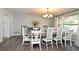 Elegant dining room featuring a large table, stylish chairs, and natural light at 26 Canter Club Ct, Debary, FL 32713