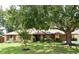 Beautiful single-story brick home with mature tree shading a manicured front yard at 26 Canter Club Ct, Debary, FL 32713
