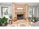 Charming brick fireplace adorned with elegant decor and flanked by bright windows at 26 Canter Club Ct, Debary, FL 32713
