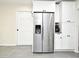 Bright kitchen with a stainless steel refrigerator, white cabinets, and a stylish coffee maker at 26 Canter Club Ct, Debary, FL 32713