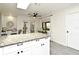 Bright kitchen featuring an island with granite countertops and modern appliances at 26 Canter Club Ct, Debary, FL 32713