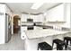 Kitchen with granite counters, white cabinets, stainless appliances, and breakfast bar at 26 Canter Club Ct, Debary, FL 32713