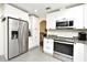 Modern kitchen features stainless steel appliances and white cabinets with dark hardware at 26 Canter Club Ct, Debary, FL 32713