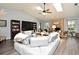 Bright and airy living room with high ceilings, modern decor, and a brick fireplace at 26 Canter Club Ct, Debary, FL 32713