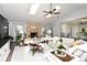 Bright living room with brick fireplace, vaulted ceiling, and abundant natural light at 26 Canter Club Ct, Debary, FL 32713