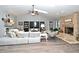 Spacious living room featuring a cozy brick fireplace and stylish furnishings at 26 Canter Club Ct, Debary, FL 32713