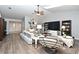 Open-concept living room with modern decor, hardwood floors, and natural light at 26 Canter Club Ct, Debary, FL 32713