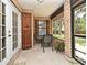 A charming outdoor patio with brick accents, seating, and a serene view of the surrounding landscape at 26 Canter Club Ct, Debary, FL 32713