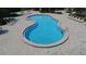 Aerial view of community pool with patio, lounge chairs, and surrounding greenery at 2622 Clarinet Dr, Orlando, FL 32837
