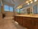 Elegant bathroom with a double vanity, soaking tub, and tiled walls for a spa-like experience at 2622 Clarinet Dr, Orlando, FL 32837